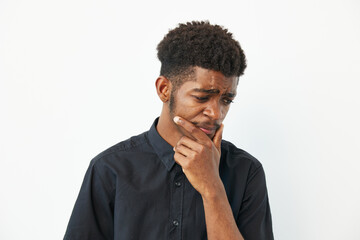 Pensive black man contemplating ideas while wearing a black shirt, showcasing deep thought and...
