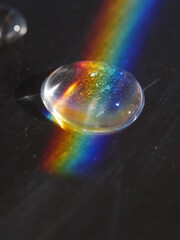 Rainbow is reflected on a glass surface