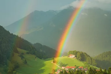 Gardinen Farbenfroh Double rainbow over a mountain landscape with a small mountain village in the Chiemgau Alps, Bavaria, Germany  © Sandra Alkado