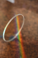 Rainbow is reflected in a glass bracelet