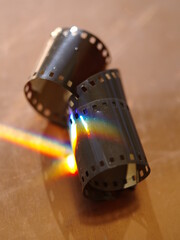 Two film reels are laying on a table, one of which is partially cut open