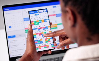 Busy Businesswoman Juggling Appointments On Laptop, Phone