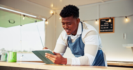Black man, owner and tablet at food truck outdoor for online order, inventory update and event planning. Smile, male person and digital with price list, menu checklist and startup vendor application