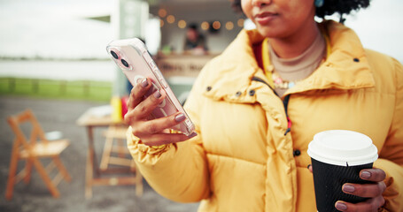 Woman, hands and phone with coffee for social media, post or review at outdoor barista stand....