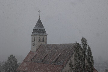 A church steeple covered in snow