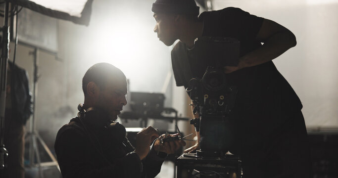Collaboration, film and videographer people in studio for footage capture or shooting content. Production, set up and teamwork with cameramen with media for behind the scenes work or cinematography