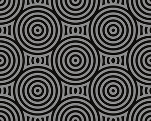 Geometric pattern featuring repeating concentric circles in black and gray tones background.