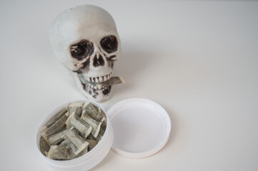Skull Chewing Tobacco on a White Table.