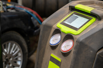 Professional AC recharge station with digital display servicing vehicle air conditioning system....