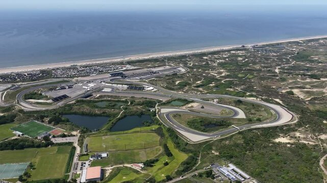 Aerial view of Zandvoort Circuit in the Netherlands, winding through dunes near North Sea coastline