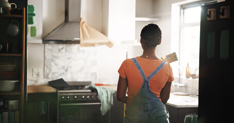DIY, paintbrush and thinking with black woman in kitchen of new house for maintenance from back....