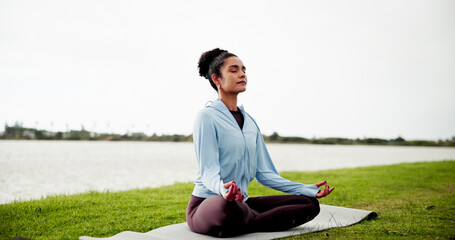 Calm, woman and grass field with mat for meditation, zen or spiritual healing by lake or river....