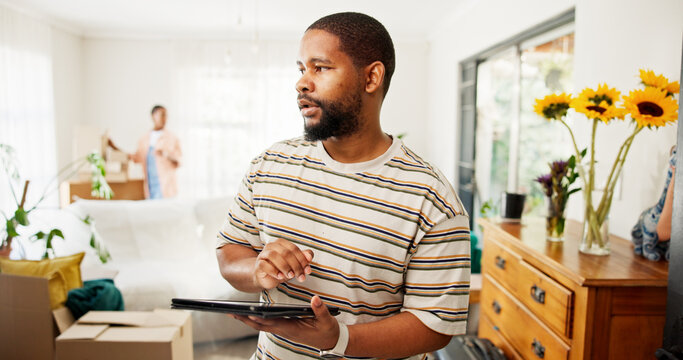 Thinking, tablet and moving with black man in new home for relocation, furniture inventory and real estate. Boxes checklist, property investment and reflection with couple in living room for planning