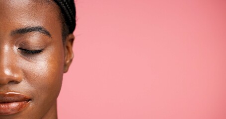 Half, face and facial treatment for woman, wellness or dermatology for glow of smooth skin or shine. Studio background, beauty and black person with eyes closed, mockup space or cosmetic for selfcare © peopleimages.com