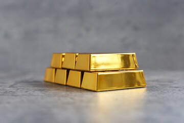 Gold bars pile on modern cement background
