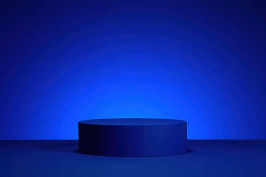 Minimalist dark blue cylindrical podium against a gradient blue background with soft lighting and shadow