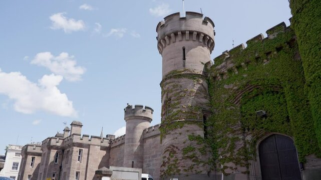Leicester HMP Prison medieval walls and towers stand tall, covered in lush ivy