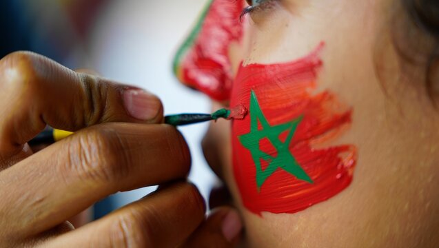 Moroccan independence day celebration with national flag face paint - Powered by Adobe