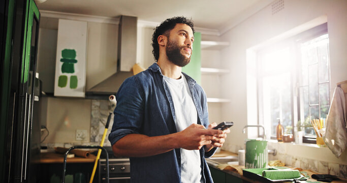 DIY, phone and thinking with man in kitchen of apartment to search for home improvement ideas. App, maintenance and renovation with homeowner in new house for interior design or online planning