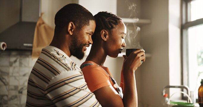Home renovation, love and couple with coffee, hug or romance on break in kitchen, paint and morning. Happy, black man and woman with caffeine, bonding or remodeling of new house, color or maintenance - Powered by Adobe