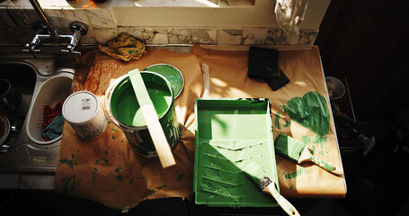 Above, paint and brushes in kitchen for home improvement, interior design and apartment...