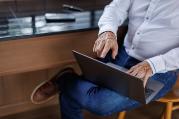 Cropped image of business man hand working laptop computer in the office 