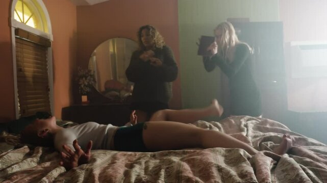 demon possessed woman writhes on a bed during exorcism