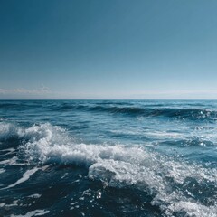 Fototapeta premium Serene ocean scene with gentle waves and bright blue sky.