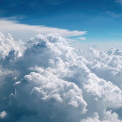Fototapeta premium A serene view of fluffy white clouds in a clear blue sky.