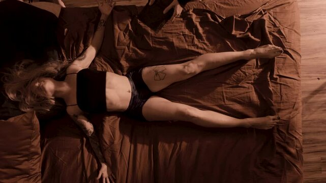 demon possessed woman writhes on a bed during exorcism