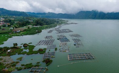 Aerial view of fish farms on Lake Batur, Bali, Indonesia. The cages are used for aquaculture,...