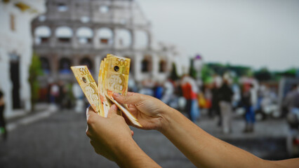 Man holding philippine pesos in a bustling italian urban setting near the roman coliseum, embodying...