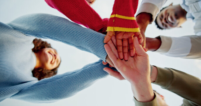 Below, people and hands stack outdoor for support, travel agreement and group solidarity. Smile, friends and huddle in circle of unity, reunion collaboration and motivation with connection on holiday