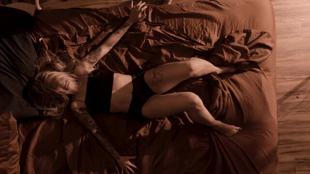 demon possessed woman writhes on a bed during exorcism
