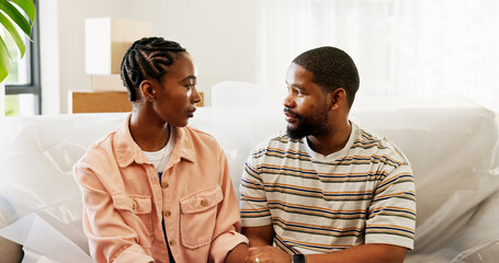 Black couple, sofa or discussion with boxes in new home for relocation, fresh start or support. African man, woman or owners with commitment in trust or care on couch for apartment, property or house