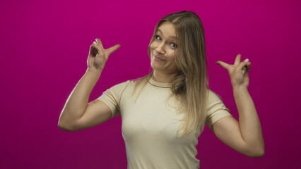 Woman gestures air quotes against vibrant pink background, expressing sarcasm with playful...