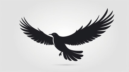 Fototapeta premium Silhouette of a black bird in full flight, wings outstretched against a light background.