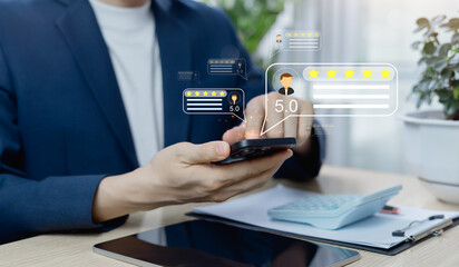 Close-up of Asian customer giving five star rating on smartphone. Hand tapping feedback icon....