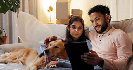 Dog, relax and tablet with couple in new home for moving house, property investment or relocation....