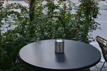 Smokers' Spot Ashtray on a Table in an Outdoor Setting