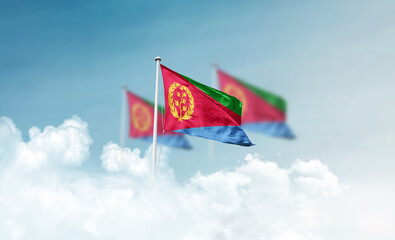 Eritrea national flags with mast waving in beautiful clouds. Eritrea flag for Republic Day and Independence Day.