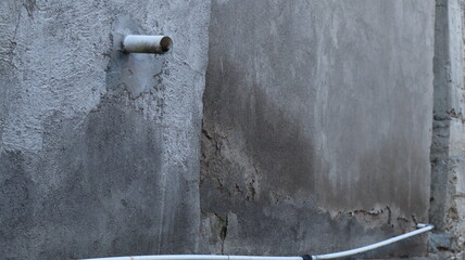 water pipe installed in gray wall