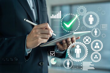 Businessman using tablet with digital interface showing analytics and human resources icons