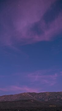 Day to night to day holy grail time-lapse of dusk falling and the night sky with the Milky Way passing over Monte Tolu, Monte San Parteo and Montemaggiore and the village of Speloncato in Corsica