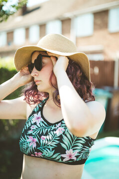 Portrait of young girl wearing hat and sunglasses, summer holidays