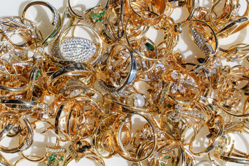 Flat lay of golden shining jewelry. Concept of jewelry store, boutique or pawnshop with scrap gold 