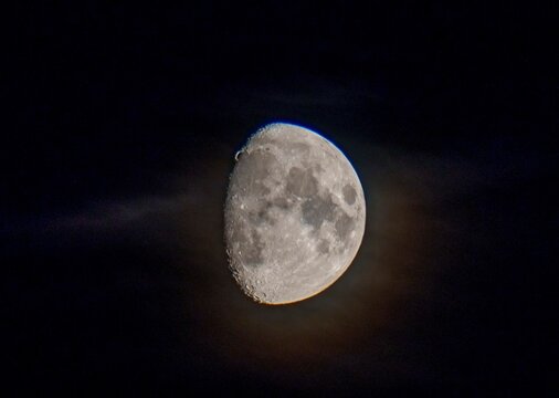 Waxing gibbous moon with soft clouds in night sky - Powered by Adobe