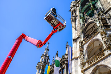 Construction equipment is positioned in a courtyard with safety cones and tools visible, ideal for...