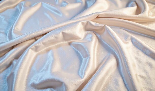 A close up of a white satin fabric.