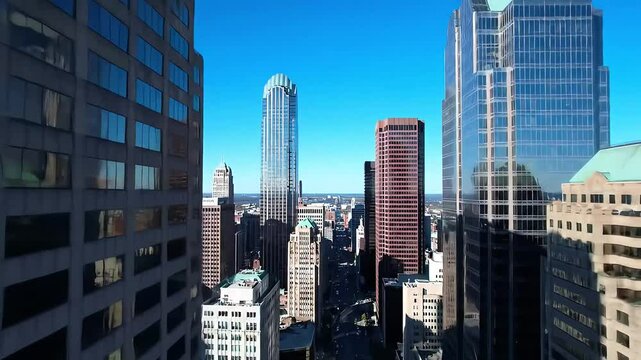 A front-facing view of a diverse city skyline featuring both classical and contemporary architecture under clear skies.